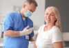 FDA Roadblock Freezes Longevity Breakthrough Smiling woman receiving a vaccination from a healthcare worker