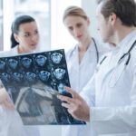 Doctors reviewing brain scan images together