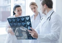 Doctors reviewing brain scan images together