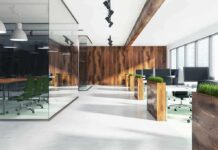 How Office Design Quietly Rewires Your Behavior Modern open-plan office with wood accents and glass meeting room