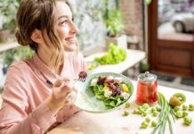 Best Foods For Healthy and Glowing Skin Woman eating a fresh salad at a bright cafe