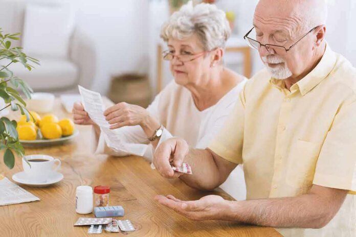Older couple organizing medication at a kitchen table