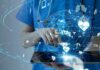 The World’s Top HealthTech Companies of 2026 Healthcare professional using a digital tablet with medical data icons