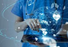 The World’s Top HealthTech Companies of 2026 Healthcare professional using a digital tablet with medical data icons