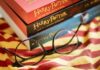 Why Page-Turners Quietly Beat Brain Decline Round black glasses on striped scarf beside Harry Potter books