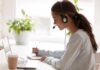 BBC Uncovers Bilingual Brain Edge Woman with headset taking notes at a laptop