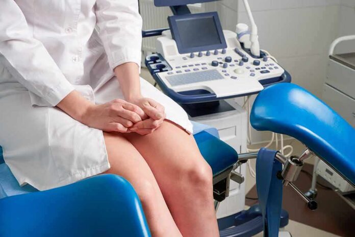 shutterstock_1661604757 Patient on gynecological exam chair beside ultrasound machine