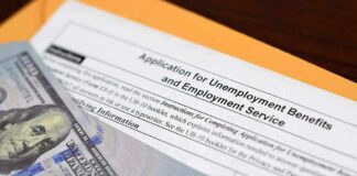 Unemployment benefits application with cash and envelope