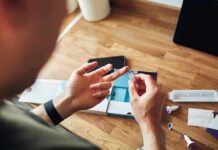Silent Deficiency Haunts Majority of American Adults Person using a finger-prick lancet for a home test kit