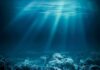 Underwater view of a coral reef with light rays penetrating the water