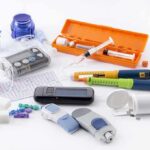 Diabetes management tools and supplies on a white surface
