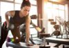 Woman performing dumbbell row in a gym