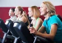 Skipping Weights? Hidden Heart Penalty group of people cycling on exercise bikes at a gym