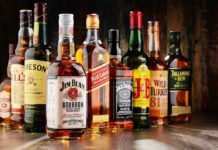 Why Older Americans Are Drinking More Alcohol Assorted whiskey bottles arranged on a wooden surface
