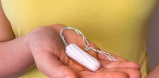 hand holding a tampon with string