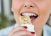 Appetite War: Cannabis vs Weight Drugs Person taking a bite of a granola bar