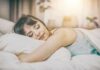 Pink noise may be bad for your sleep, new research finds Woman sleeping on a bed