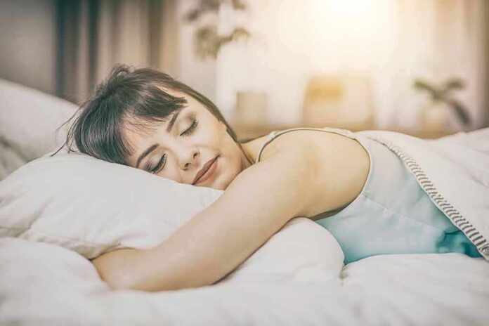 shutterstock_613463918 Woman sleeping on a bed