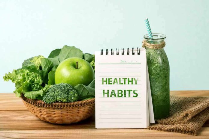 Basket of green vegetables with apple, notebook, and green smoothie