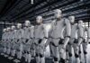 Rows of humanoid robots standing in a warehouse