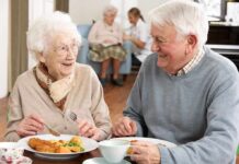 Aging Clues Emerge In One Simple Test Two seniors smiling while eating a meal together at a table