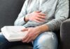 Cancer Flags Found in Everyday Food Packaging Person holding takeout container while touching stomach