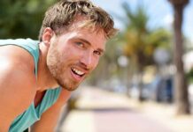 The Zone 2 Fitness Trap man in athletic tank top resting outdoors