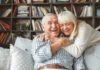 This Unexpected Activity Helped Ease Depression & Improve Happiness Older couple hugging and laughing on a couch