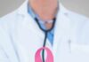 Early Cancer Signal Hiding In Your Blood Doctor holding stethoscope with pink ribbon in front