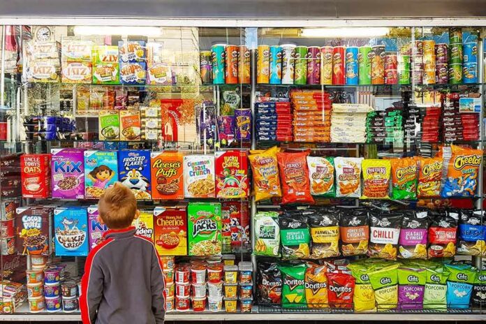 Child looking at a shop window filled with snacks and cereals