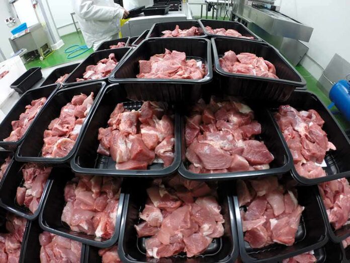 shutterstock_1132114742 Trays of raw meat in a processing facility