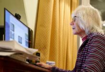Older woman using a desktop computer at a desk