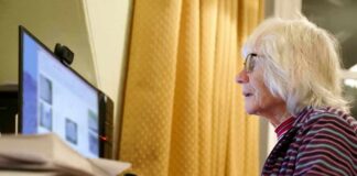 Older woman using a desktop computer at a desk