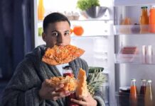 Late Bites, Liver Damage man in robe eating pizza at open refrigerator