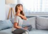 Stronger Bones? Wrong Battle, Say Docs Woman sitting on couch holding her neck