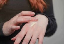 Skinspan: A Holistic Roadmap for Extending Skin Longevity Hands applying cream on the back of a hand