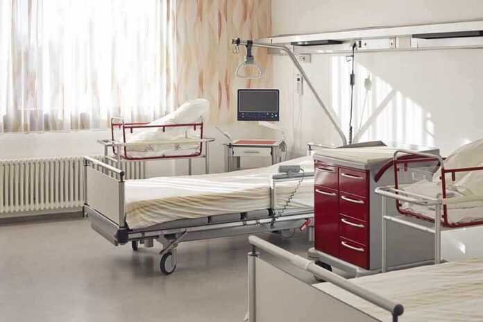 A hospital room featuring empty patient beds and medical equipment
