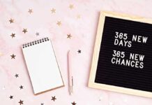 Letter board with notebook and pen on pink background