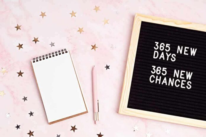 shutterstock_1855980214 Letter board with notebook and pen on pink background