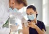 America’s Health Care Workforce Crisis Healthcare worker giving a masked patient a vaccine in the upper arm