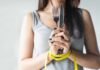 Holiday Weight: Sneaky Swaps Slash Holiday Calories Woman with measuring tape around wrists holding fork and knife