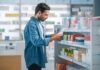 Man shopping in a pharmacy aisle