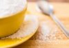 Yellow bowl and plate with spilled granulated sugar