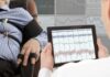 FDA-Approved Brain Tech Outsmarts Seizures Technician reviews polygraph readings on a tablet beside a seated subject